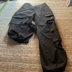 Cargo pants, Black. Scrunches at the bottom & can stay lose. Pockets on back.